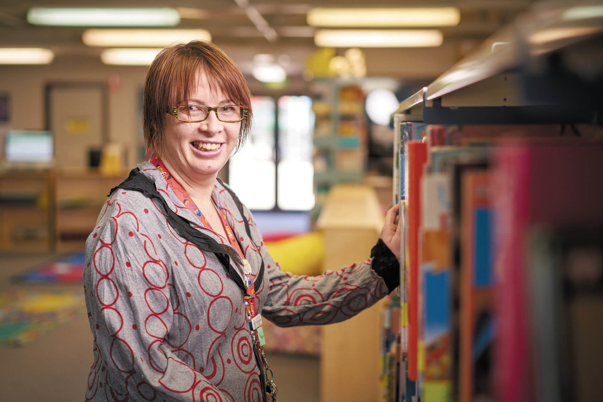 Tansy smiles in a school library