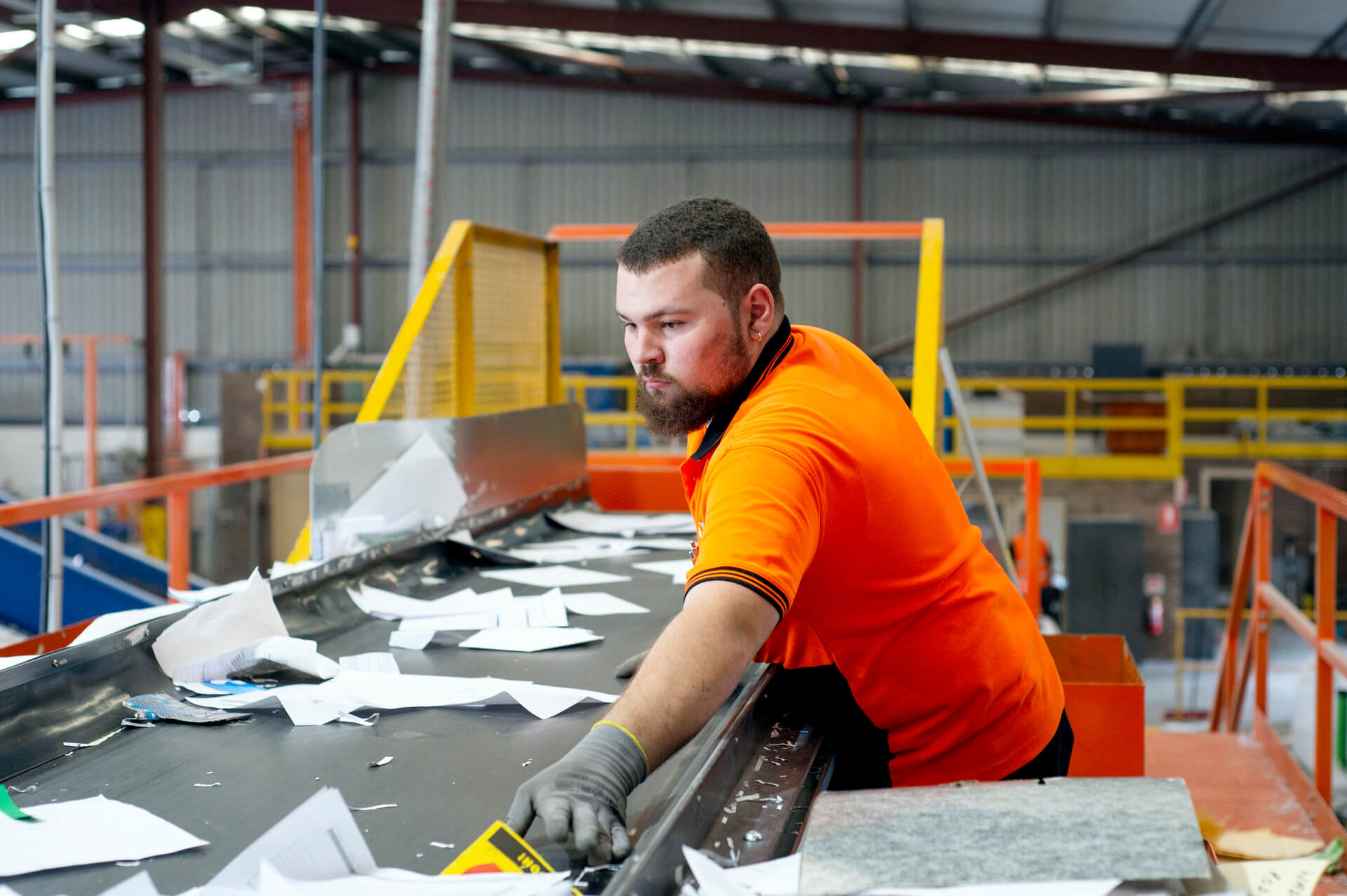 An autistic employee works in a scrap paper factory