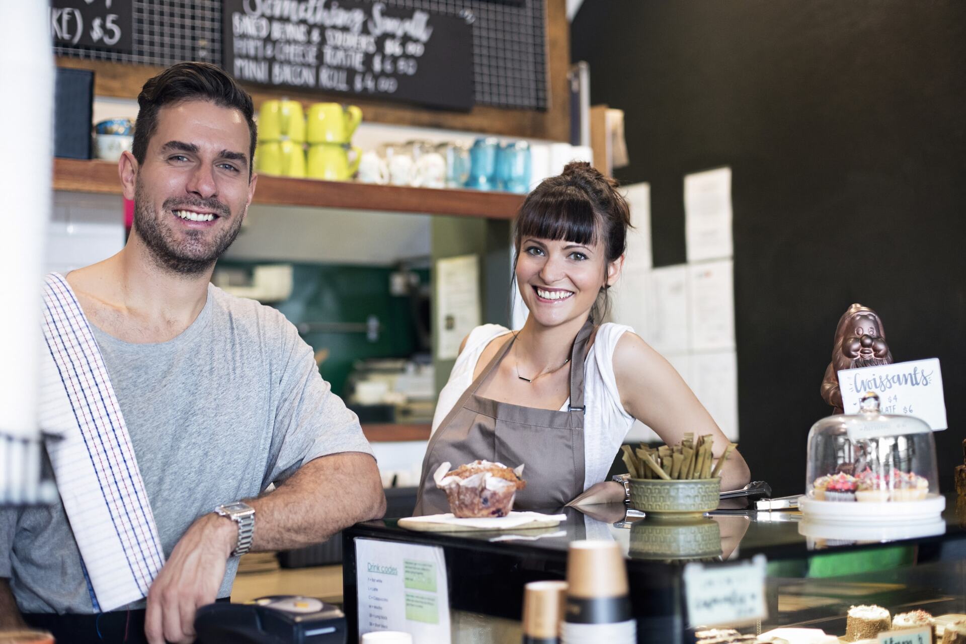 Male cafe employee standing at counter