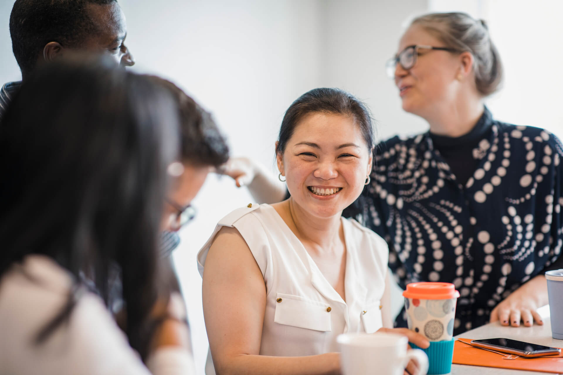 A woman smiling as APM provides Disability Employment Services in other languages
