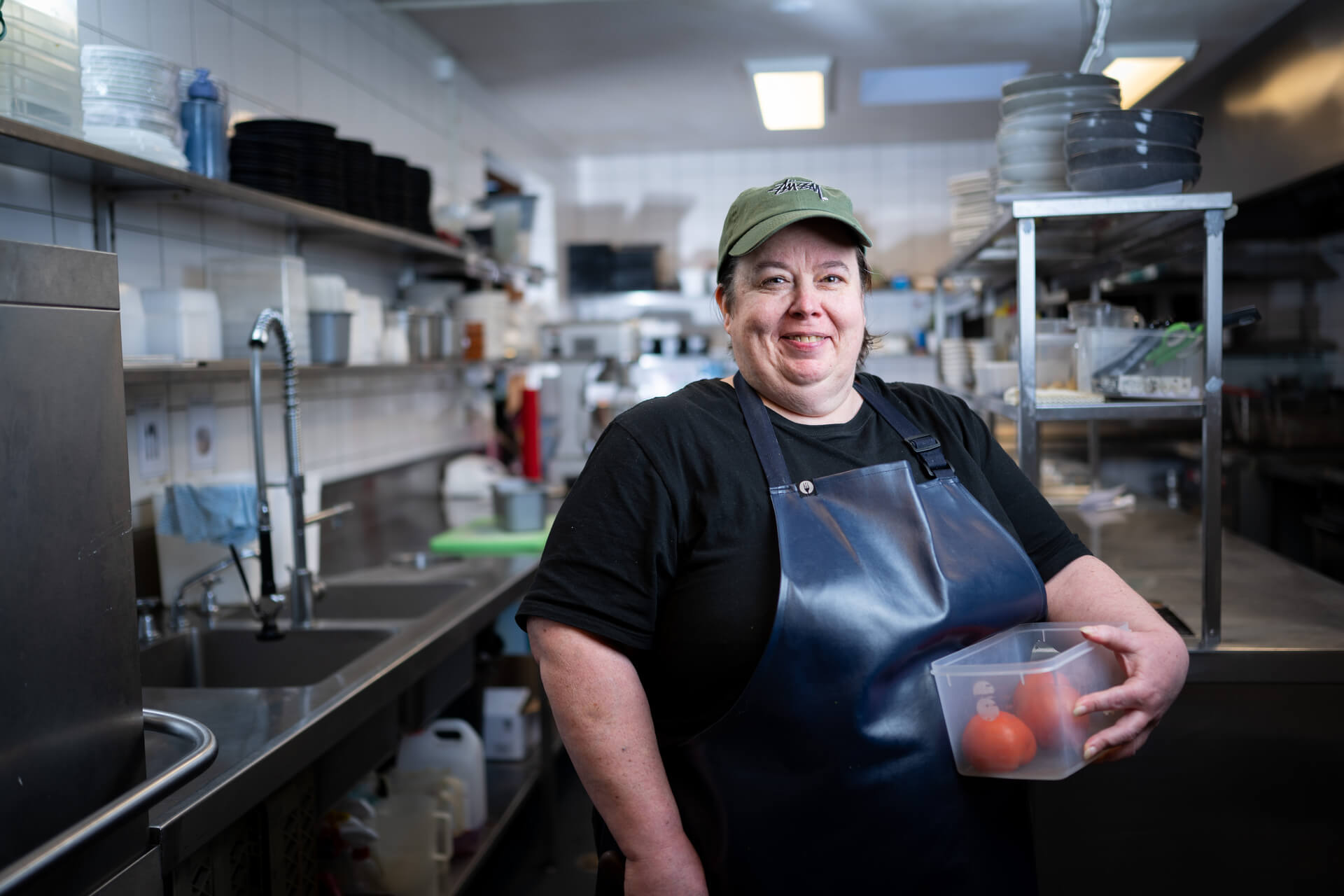 DES participant Melissa in a cap and apron in a kitchen 