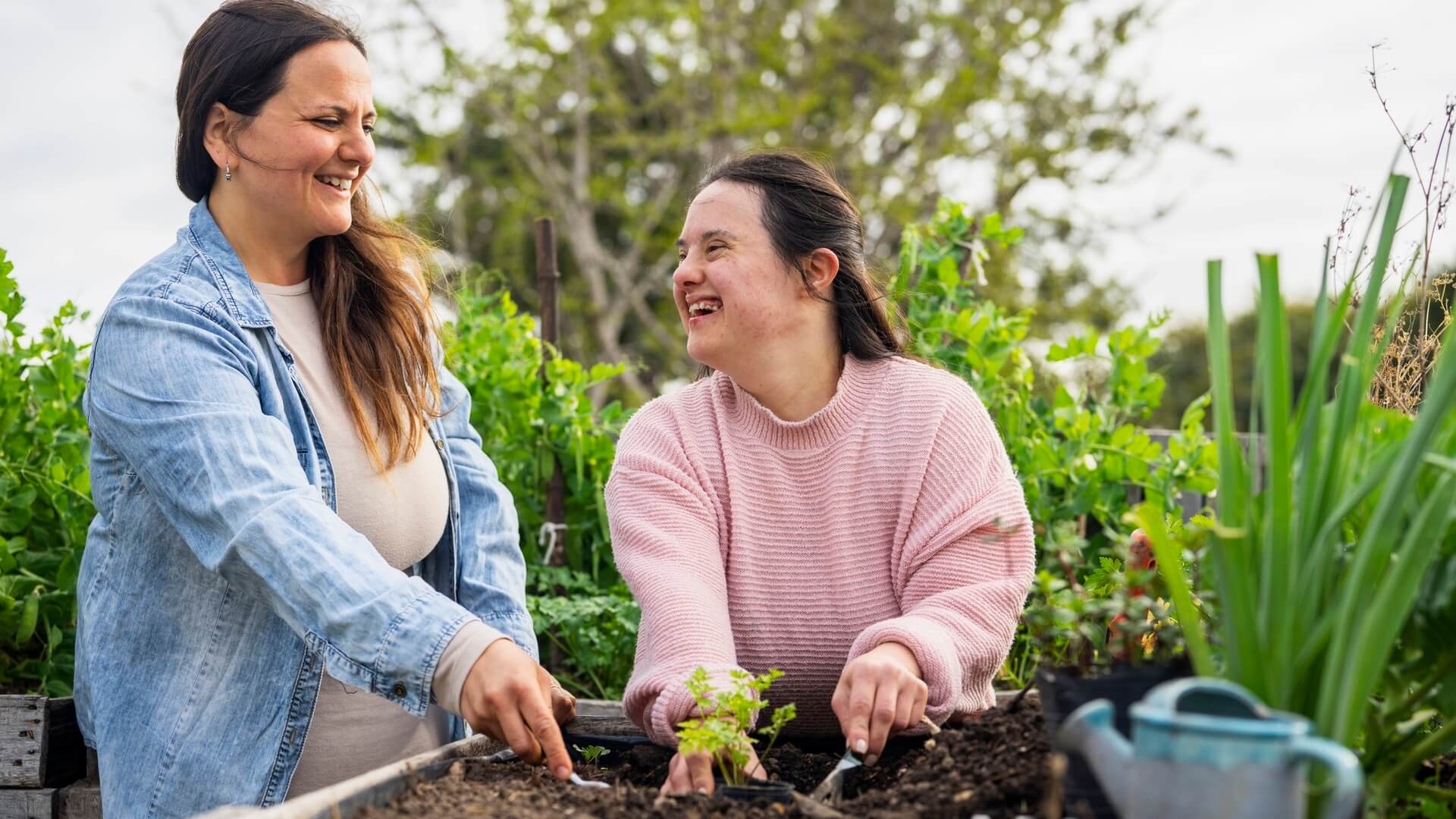 A mother and daughter doing some gardening