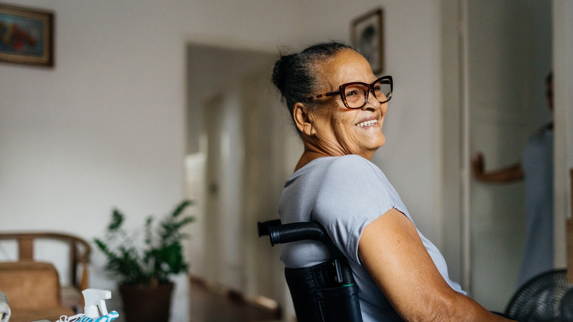 A smiling woman in a wheelchair