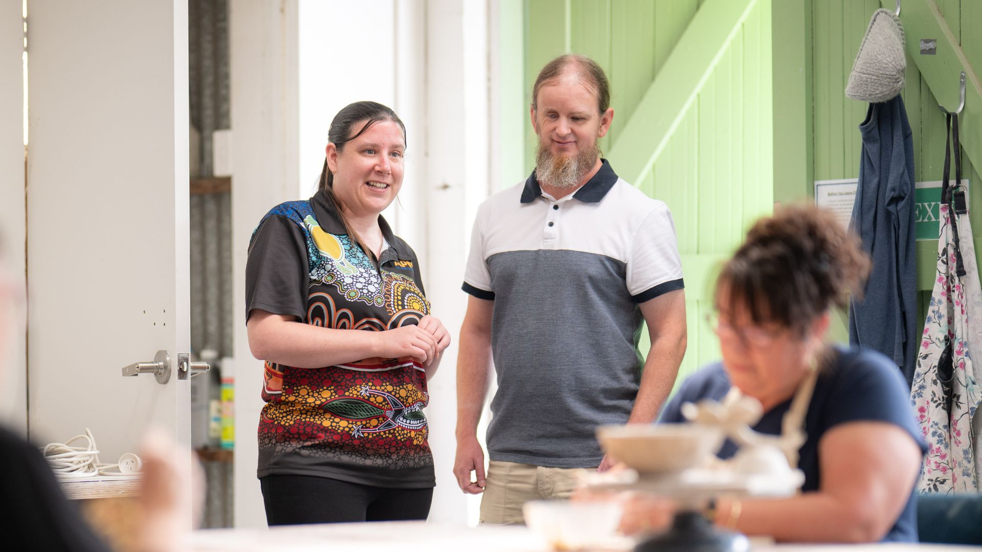 Ben and Kim from APM standing in an arts class