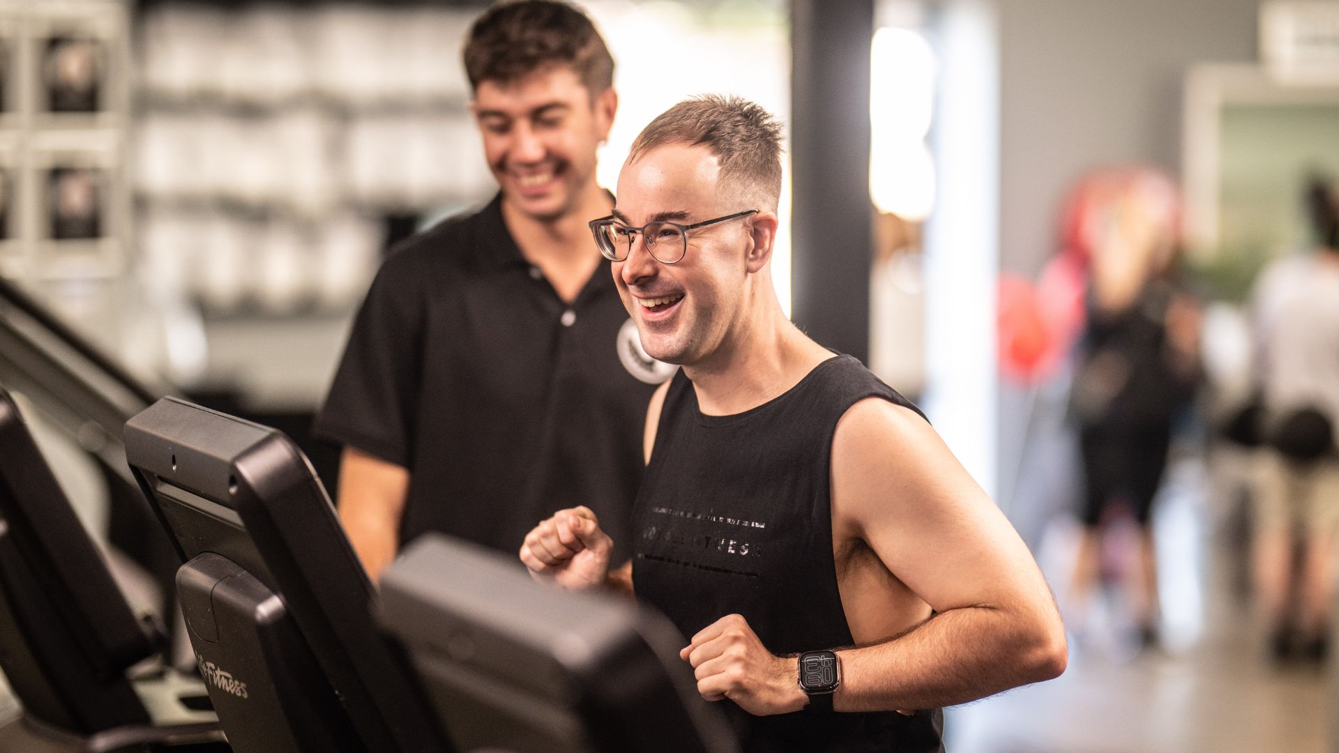 Pat a participant with disability running in a gym