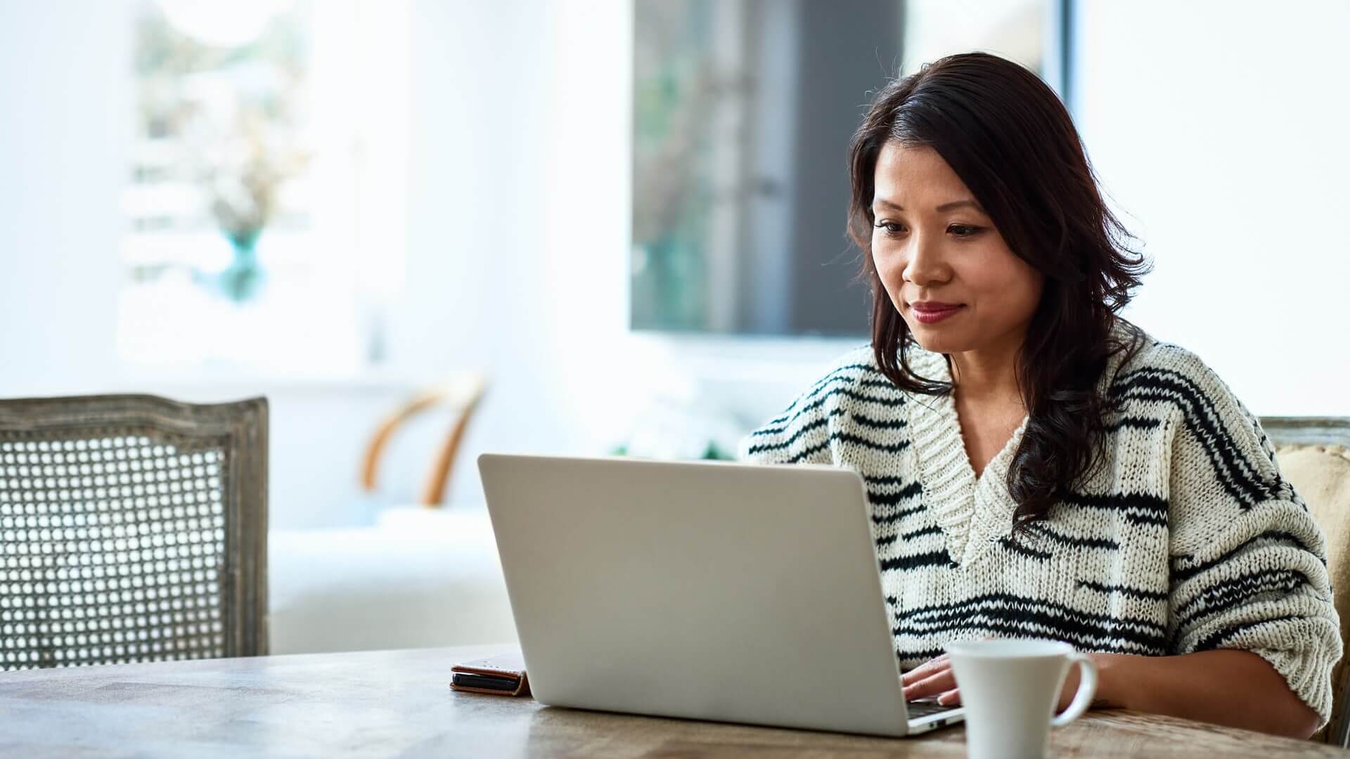 A woman working on her laptop at home